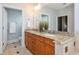 Bathroom featuring double sink vanity, tile flooring and access to separate toilet and shower at 1227 Ashford Creek Ne Park, Atlanta, GA 30319