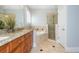 Bathroom featuring a separate shower, soaking tub, and double sink vanity with granite counters at 1227 Ashford Creek Ne Park, Atlanta, GA 30319