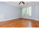 Bright bedroom featuring hardwood floors, fresh paint, crown molding, and plantation shutters at 1227 Ashford Creek Ne Park, Atlanta, GA 30319