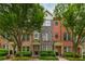 Charming townhouses feature varied brick and stone facades, complemented by lush green trees and manicured landscaping at 1227 Ashford Creek Ne Park, Atlanta, GA 30319