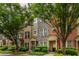 Charming townhomes featuring brick and stone exteriors with well-manicured landscaping and mature trees at 1227 Ashford Creek Ne Park, Atlanta, GA 30319