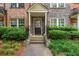 Inviting front porch with stone accents, a covered entry, and lush landscaping at 1227 Ashford Creek Ne Park, Atlanta, GA 30319