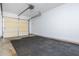 Clean and functional garage space with door and a textured floor at 1227 Ashford Creek Ne Park, Atlanta, GA 30319