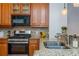 Close-up of the kitchen's stainless steel appliances, granite countertops, and wooden cabinetry at 1227 Ashford Creek Ne Park, Atlanta, GA 30319