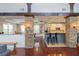 Open-concept kitchen featuring stone pillars, stainless steel appliances, and an island with bar stool seating at 1227 Ashford Creek Ne Park, Atlanta, GA 30319