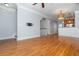 Open-concept living area with hardwood floors, access to the kitchen, and modern lighting at 1227 Ashford Creek Ne Park, Atlanta, GA 30319