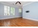Open living area with hardwood floors, neutral paint, and plantation shutters on the windows at 1227 Ashford Creek Ne Park, Atlanta, GA 30319