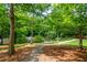 Scenic view of a pond surrounded by lush trees, foliage, and a walking path at 1227 Ashford Creek Ne Park, Atlanta, GA 30319
