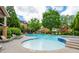 Community swimming pool with lounge chairs, landscaped surroundings, and nearby buildings in a residential neighborhood at 1227 Ashford Creek Ne Park, Atlanta, GA 30319
