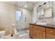 Bright bathroom featuring a glass shower, beige tile, and modern vanity with vessel sink at 1241 Briarcliff Ne Rd, Atlanta, GA 30306