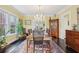 Elegant dining room with chandelier lighting, large windows, and hardwood floors at 1241 Briarcliff Ne Rd, Atlanta, GA 30306