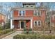 Charming two-story red brick home with inviting front porch and professionally landscaped front yard at 1241 Briarcliff Ne Rd, Atlanta, GA 30306