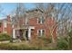 Traditional two-story brick home with covered porch, lush landscaping, and mature trees at 1241 Briarcliff Ne Rd, Atlanta, GA 30306