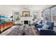 Bright living room featuring a fireplace, large windows, modern furniture, and an ornate rug at 1241 Briarcliff Ne Rd, Atlanta, GA 30306