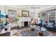 This bright living room includes a fireplace, large windows, furniture, and an ornate rug at 1241 Briarcliff Ne Rd, Atlanta, GA 30306