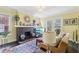 Bright living room featuring a brick fireplace, hardwood floors, and stylish furniture at 1241 Briarcliff Ne Rd, Atlanta, GA 30306