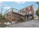 Expansive brick home featuring a large deck, an open carport and ample driveway parking at 1241 Briarcliff Ne Rd, Atlanta, GA 30306