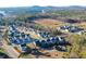 An aerial view showcases an established neighborhood surrounded by trees and a view of the lake at 135 Kingsley Way, Acworth, GA 30102