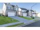 Exterior view of new homes along a well-manicured street with green lawns and clear skies at 135 Kingsley Way, Acworth, GA 30102