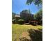 Spacious backyard featuring a wood deck and lush green lawn at 5250 Mountain Village Ct, Stone Mountain, GA 30083