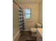 Bathroom featuring modern toilet, wood look flooring, bathtub and a window at 5250 Mountain Village Ct, Stone Mountain, GA 30083