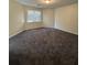 A large bedroom with neutral carpeting and window letting in natural light at 5250 Mountain Village Ct, Stone Mountain, GA 30083