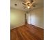 Bright bedroom with hardwood flooring and ceiling fan at 5250 Mountain Village Ct, Stone Mountain, GA 30083
