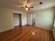 Bright bedroom with hardwood flooring, closet, and ceiling fan at 5250 Mountain Village Ct, Stone Mountain, GA 30083