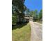 Charming two-story home with green siding, stone accents, and a well-maintained front yard at 5250 Mountain Village Ct, Stone Mountain, GA 30083