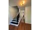 Inviting foyer with a staircase featuring black painted railings at 5250 Mountain Village Ct, Stone Mountain, GA 30083