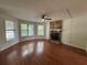 Bright living room featuring hardwood floors and a stone fireplace at 5250 Mountain Village Ct, Stone Mountain, GA 30083