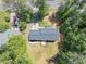 Aerial view of the home shows the roof, yard, driveway, and surrounding trees at 212 Lake Forest Dr, Acworth, GA 30102