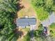 An aerial view of a house and its surrounding landscape, complete with trees and a gray rooftop at 212 Lake Forest Dr, Acworth, GA 30102