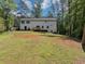 Backyard features a large lawn and treeline at 212 Lake Forest Dr, Acworth, GA 30102