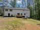 Backyard features a deck, a tree line, and a large lawn at 212 Lake Forest Dr, Acworth, GA 30102
