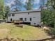 Spacious backyard includes a wooden deck, a tree line and a large lawn at 212 Lake Forest Dr, Acworth, GA 30102