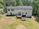 A view of the backyard, featuring a white two-story home with a wooden deck at 212 Lake Forest Dr, Acworth, GA 30102