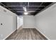 Spacious finished basement featuring modern flooring, open ceiling, and great natural light at 212 Lake Forest Dr, Acworth, GA 30102