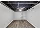 Spacious unfinished basement with structural ceiling, hardwood flooring, and ample space ready to be customized at 212 Lake Forest Dr, Acworth, GA 30102