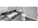 Bathroom featuring stylish granite countertop and hardwood floors at 212 Lake Forest Dr, Acworth, GA 30102