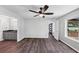 This bedroom is well lit and inviting with a ceiling fan, neutral color scheme, and hardwood flooring at 212 Lake Forest Dr, Acworth, GA 30102