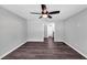 This bedroom is well lit and inviting with a ceiling fan, neutral color scheme, and hardwood flooring at 212 Lake Forest Dr, Acworth, GA 30102