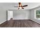 This bedroom features a ceiling fan, wood floors, bright white walls, and abundant natural light at 212 Lake Forest Dr, Acworth, GA 30102