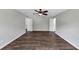 Bedroom featuring a ceiling fan, wood floors, bright white walls, and abundant natural light from multiple windows at 212 Lake Forest Dr, Acworth, GA 30102