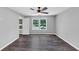 This bedroom is well lit and inviting with a ceiling fan, neutral color scheme, and hardwood flooring at 212 Lake Forest Dr, Acworth, GA 30102