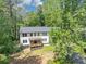 A beautiful two story home with a charming front porch and lush landscaping at 212 Lake Forest Dr, Acworth, GA 30102