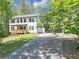 Two-story house with a gray roof, a nice front porch, and plenty of parking at 212 Lake Forest Dr, Acworth, GA 30102