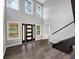 A bright foyer with soaring ceilings, wood floors and an elegant black-framed front door at 212 Lake Forest Dr, Acworth, GA 30102