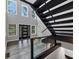 Bright foyer with soaring ceilings, modern staircase, wood floors and black-framed entry door at 212 Lake Forest Dr, Acworth, GA 30102