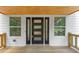 Front door with sidelights, wood deck, and white siding creates a welcoming entrance at 212 Lake Forest Dr, Acworth, GA 30102